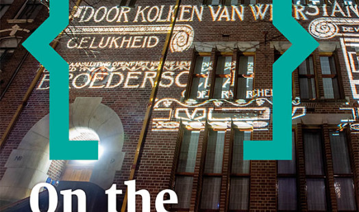 Cover of On the Waterfront 40. Nocturnal photo of the light projection of a historical image on the façade of the union building De Burcht in Amsterdam in December 2019.